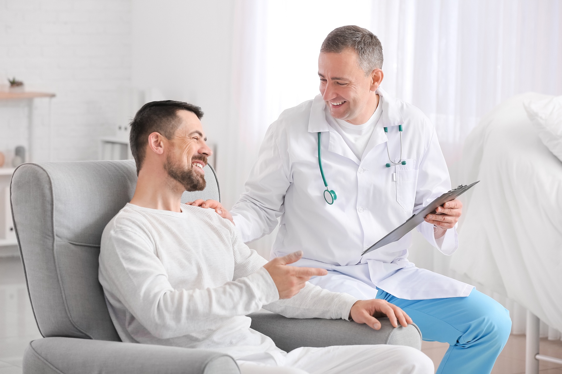 Doctor and man undergoing course of chemotherapy in clinic. Prostate cancer awareness concept